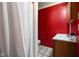 Functional bathroom with a shower, toilet, and vanity, featuring bright red walls at 2911 N 200 W Rd, Franklin, IN 46131