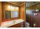 Rustic bathroom features vintage wood paneling, unique decor, and updated fixtures at 2911 N 200 W Rd, Franklin, IN 46131