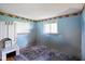 Simple bedroom with blue walls, a window, a small bench, and dog-themed wallpaper border at 2911 N 200 W Rd, Franklin, IN 46131