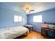 Bright bedroom featuring hardwood floors, a ceiling fan, and a light blue paint scheme at 2911 N 200 W Rd, Franklin, IN 46131