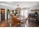 Bright dining room with hardwood floors, decorative light fixture, and ample seating at the wooden table at 2911 N 200 W Rd, Franklin, IN 46131