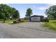 View of the detached garage, home, and vintage truck on a well-maintained lot at 2911 N 200 W Rd, Franklin, IN 46131