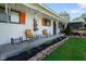 Cozy front porch features seating, hanging plants, and charming decor at 2911 N 200 W Rd, Franklin, IN 46131