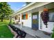 Inviting front porch with a 'welcome' sign, hanging plants, and seating at 2911 N 200 W Rd, Franklin, IN 46131