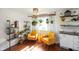 Bright and airy living room featuring yellow armchairs, hardwood floors, and industrial-style shelving at 2911 N 200 W Rd, Franklin, IN 46131