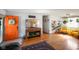 Cozy living room featuring bright orange door, eclectic decor, and refinished hardwood floors at 2911 N 200 W Rd, Franklin, IN 46131
