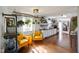 Open-concept living room and kitchen with bright yellow armchairs and unique decor at 2911 N 200 W Rd, Franklin, IN 46131