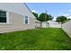 A spacious backyard featuring a detached shed, complemented by a grassy area, swing set, and a wooden fence at 3059 Tansel Rd, Indianapolis, IN 46234