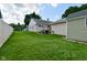 Serene backyard with a detached storage shed and lush green grass extending to the home and wooden fence at 3059 Tansel Rd, Indianapolis, IN 46234