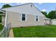 Beige house exterior featuring white trim, green lawn, and partial view of garage with a swing at 3059 Tansel Rd, Indianapolis, IN 46234