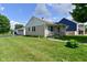 Charming home with a well-manicured lawn, driveway, and a detached garage/carport offering ample parking space at 3059 Tansel Rd, Indianapolis, IN 46234