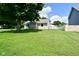Charming home with a well-manicured lawn and a large tree, creating a serene and inviting curb appeal at 3059 Tansel Rd, Indianapolis, IN 46234