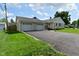 View of the home and the attached two car garage with a paved driveway and well maintained lawn at 3059 Tansel Rd, Indianapolis, IN 46234