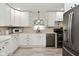 Bright kitchen featuring white cabinets, modern appliances, and light countertops with a window at 3059 Tansel Rd, Indianapolis, IN 46234
