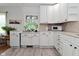 A kitchen featuring white cabinets and light countertops with plants in the window at 3059 Tansel Rd, Indianapolis, IN 46234