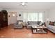 Cozy living room featuring hardwood floors, comfortable seating, and plenty of natural light at 3059 Tansel Rd, Indianapolis, IN 46234