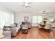 Bright and airy living room featuring hardwood floors and an open layout to dining area at 3059 Tansel Rd, Indianapolis, IN 46234