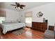 A cozy bedroom featuring hardwood floors, a large dresser, and soft, natural lighting at 3059 Tansel Rd, Indianapolis, IN 46234