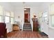 Inviting sun room with ample natural light, wood-look floors, and access to the outdoors at 3059 Tansel Rd, Indianapolis, IN 46234