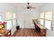 Versatile sunroom with tile floors, windows, ceiling fan, and desk setup at 3059 Tansel Rd, Indianapolis, IN 46234