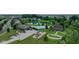 Aerial view capturing a community pool, playground, and picnic area, highlighting recreational amenities by a pond at 3075 W Crosscreek Dr, Monrovia, IN 46157