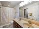 Bathroom featuring a double sink vanity with decorative countertop and shower-tub combination at 3075 W Crosscreek Dr, Monrovia, IN 46157