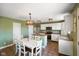 Charming kitchen with white cabinets, stainless appliances, and adjacent dining area, great for gatherings at 3075 W Crosscreek Dr, Monrovia, IN 46157