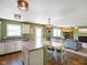 Bright kitchen with a breakfast bar, stainless steel appliances, flowing into a cozy living room with fireplace at 3075 W Crosscreek Dr, Monrovia, IN 46157
