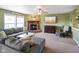 Comfortable living room features a brick fireplace, soft gray sectional sofa and lots of natural light at 3075 W Crosscreek Dr, Monrovia, IN 46157