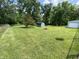 Spacious green backyard features a small storage shed and mature trees along the fence line at 31 S Sugar Creek Dr, New Palestine, IN 46163