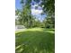 Expansive green backyard with a storage shed and mature trees at 31 S Sugar Creek Dr, New Palestine, IN 46163