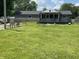 View of backyard featuring green lawn, seating, and back porch with screened in area at 31 S Sugar Creek Dr, New Palestine, IN 46163