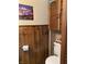 Rustic bathroom featuring wood paneling, vintage accessories, and unique decor at 31 S Sugar Creek Dr, New Palestine, IN 46163
