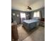 Comfortable bedroom with a large bed, ceiling fan, natural light, and neutral decor at 31 S Sugar Creek Dr, New Palestine, IN 46163
