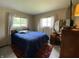Cozy bedroom with a comfortable bed, bright windows, and vintage furnishings at 31 S Sugar Creek Dr, New Palestine, IN 46163