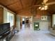 Cozy living room with wood-paneled ceiling, exposed brick, and open layout at 31 S Sugar Creek Dr, New Palestine, IN 46163