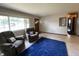 Bright living room with comfortable seating, large window, and open access to other rooms at 31 S Sugar Creek Dr, New Palestine, IN 46163