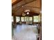 Bright sunroom with wood-paneled walls, ceiling, large windows, and comfortable seating at 31 S Sugar Creek Dr, New Palestine, IN 46163
