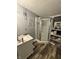 Bathroom featuring a corner shower, modern vanity, and wood-look flooring at 3301 S Lockburn St, Indianapolis, IN 46221