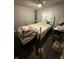 Cozy bedroom with hardwood flooring and a soft bed against a brick wall at 3301 S Lockburn St, Indianapolis, IN 46221