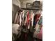 This closet features metal racks and a variety of hanging clothes with containers on the upper shelf at 3301 S Lockburn St, Indianapolis, IN 46221