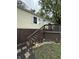 Charming home exterior featuring a wooden deck, stairs, and decorative flower garden at 3301 S Lockburn St, Indianapolis, IN 46221