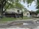 View of a two yellow houses with a fenced yard and an old driveway at 3301 S Lockburn St, Indianapolis, IN 46221