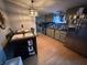 Traditional kitchen featuring an island and wood laminate floors at 3301 S Lockburn St, Indianapolis, IN 46221