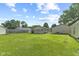 Spacious backyard with lush grass, mature trees, and neighboring residential buildings at 3304 Coffey St, Indianapolis, IN 46217