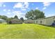 Extensive backyard featuring a vast lawn, trees, and multiple buildings at 3304 Coffey St, Indianapolis, IN 46217