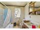 Compact bathroom with a tub, vanity, and natural light at 3304 Coffey St, Indianapolis, IN 46217