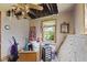 Bedroom with exposed rafters and a damaged ceiling, ladder and window at 3304 Coffey St, Indianapolis, IN 46217