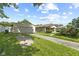 Charming home exterior with a detached garage, gravel driveway, and green lawn at 3304 Coffey St, Indianapolis, IN 46217