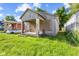 This property needs work, including overgrown grass and boarded-up windows at 3335 W 9Th St, Indianapolis, IN 46222